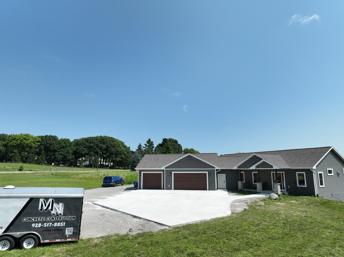 Newly Constructed home with a new concrete driveway on a beautiful Wisconsin Summer day.