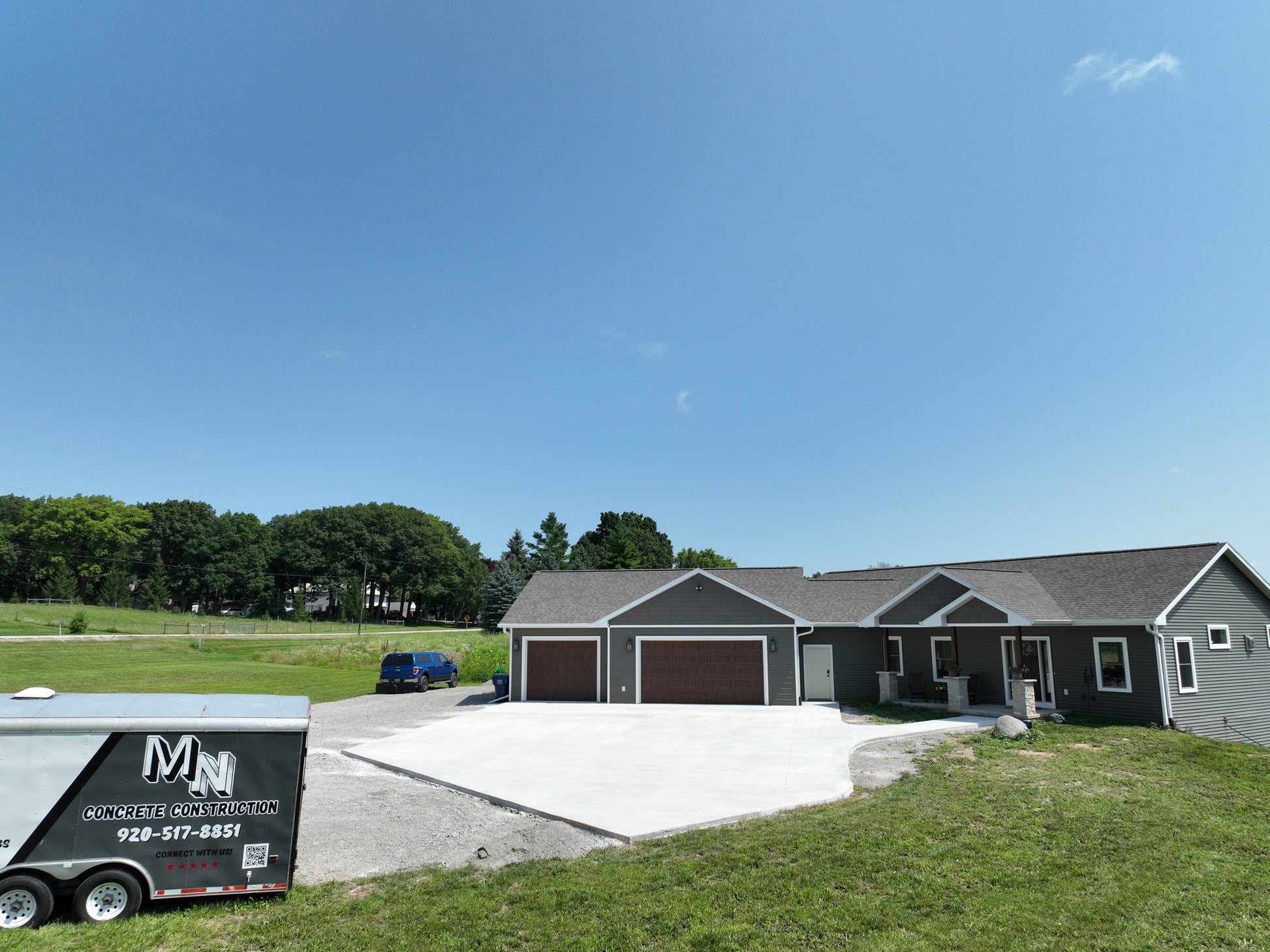 Newly Constructed home with a new concrete driveway on a beautiful Wisconsin Summer day.