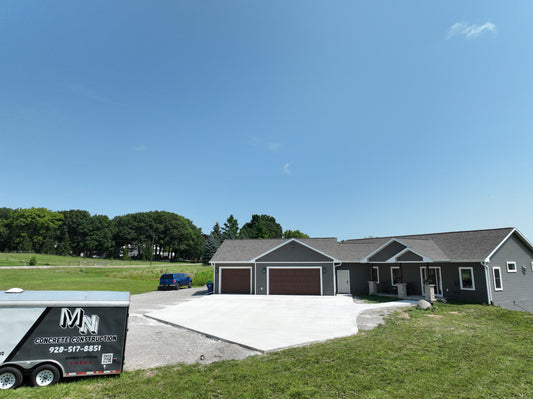 Newly Constructed home with a new concrete driveway on a beautiful Wisconsin Summer day.